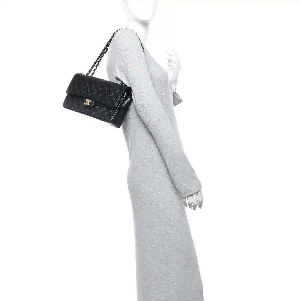 Black quilted caviar leather shoulder bag with gold chain, worn crossbody