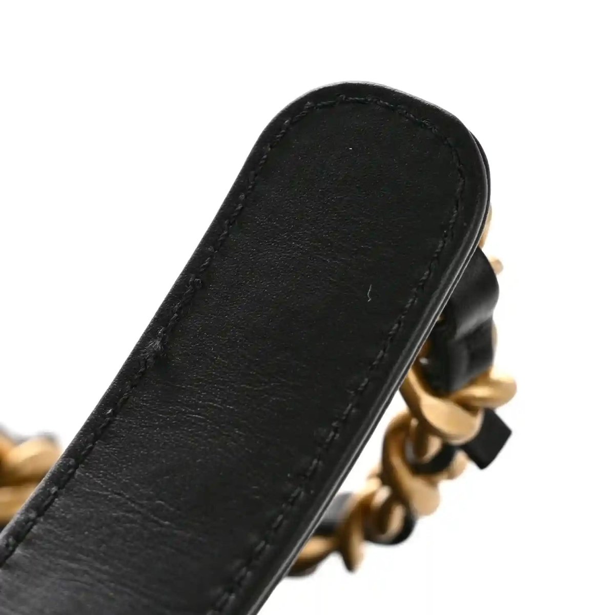 Black leather strap connector with gold chain hardware on quilted shoulder bag