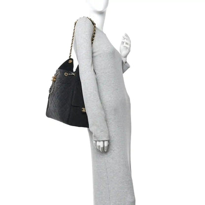 Chanel medium quilted denim shoulder bag with gold chain strap and top handle