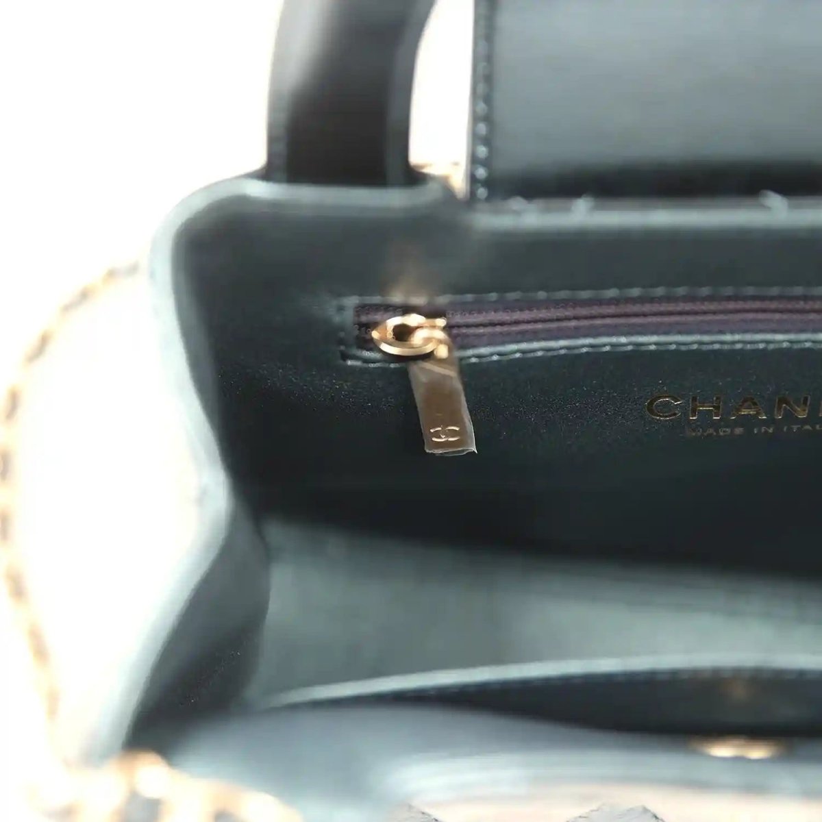 Kelly shopper interior close-up with gold zipper pull and CHANEL label