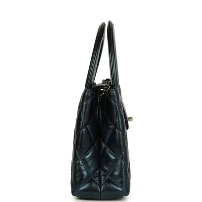 Metallic blue quilted Kelly shopper bag side view with gold-toned hardware