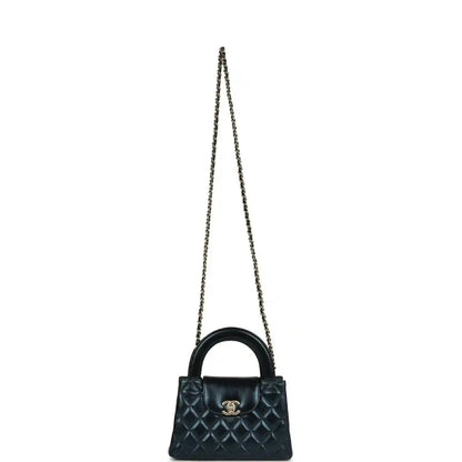 Metallic blue quilted Kelly shopper bag on a chain strap with Chanel logo