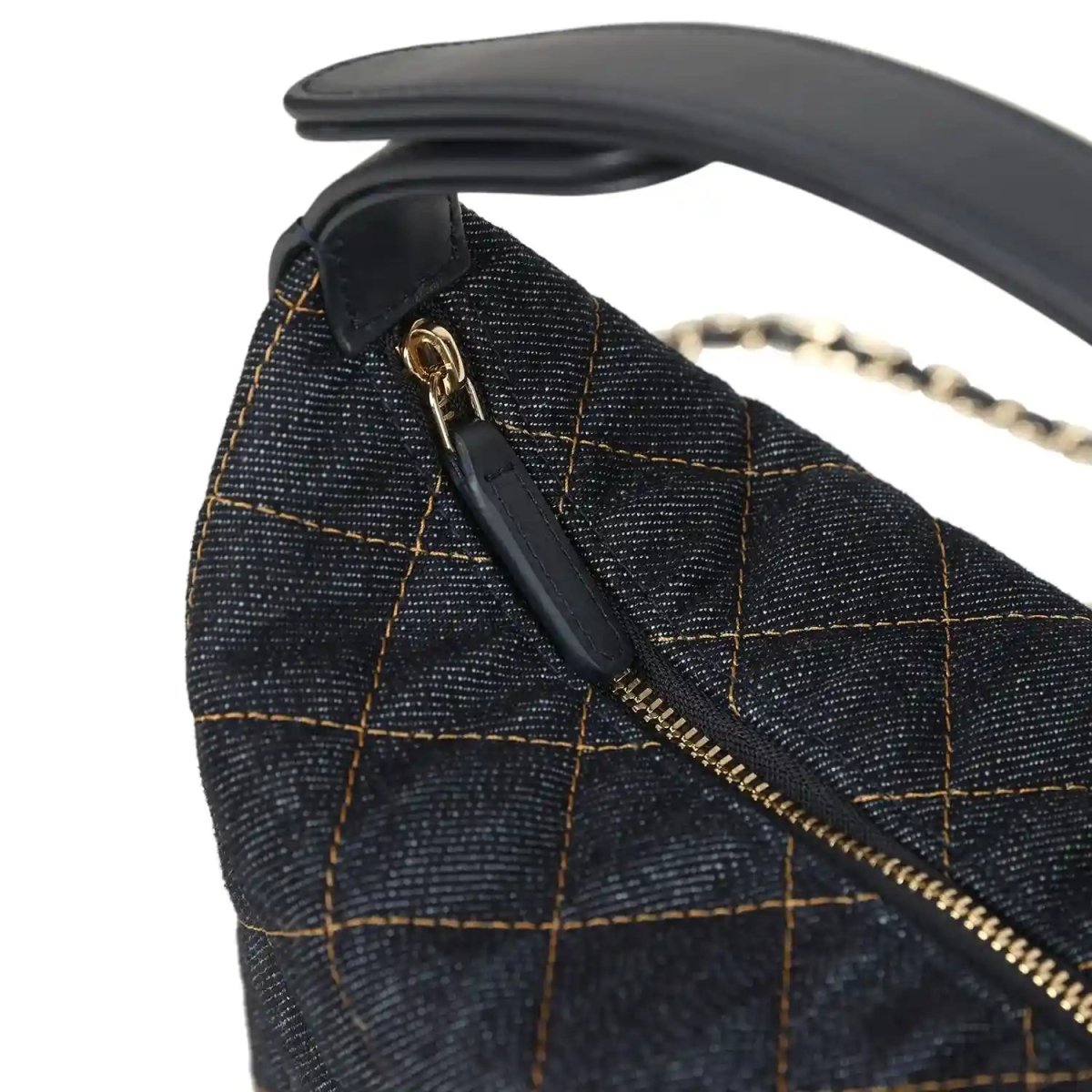 Chanel mini hobo pouch detail: denim flap with gold zipper and small logo hardware