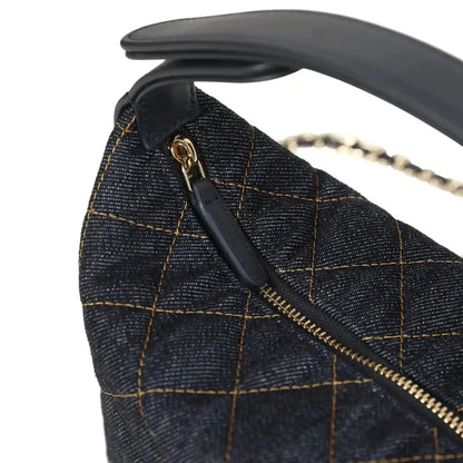 Chanel mini hobo pouch detail: denim flap with gold zipper and small logo hardware