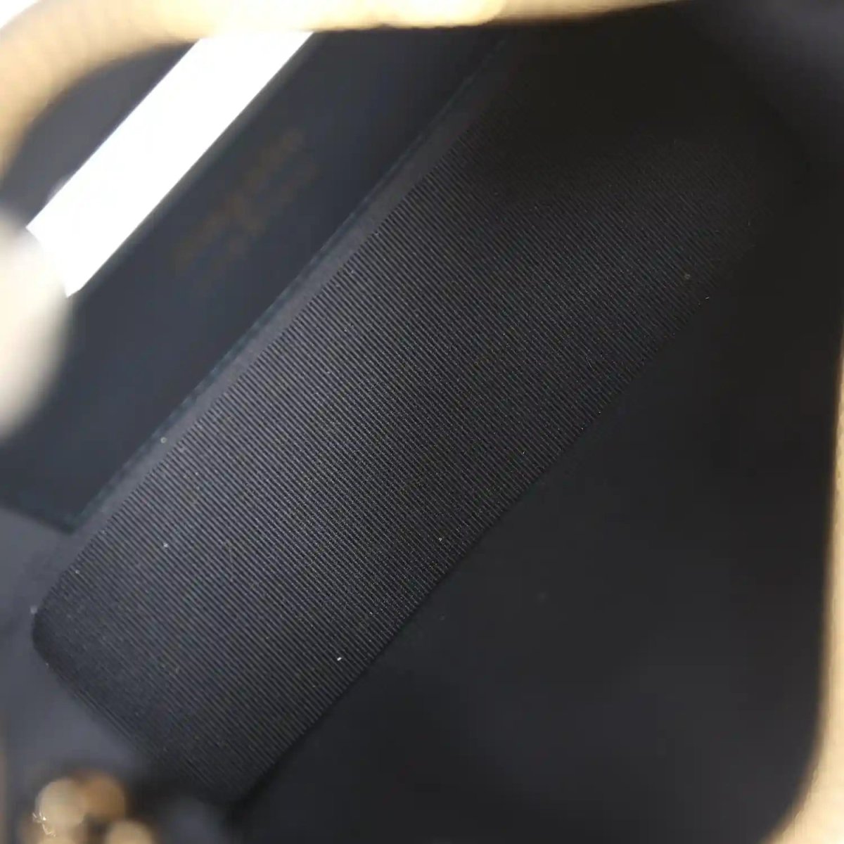 Chanel mini hobo pouch interior close-up with dark lining and stitched edge