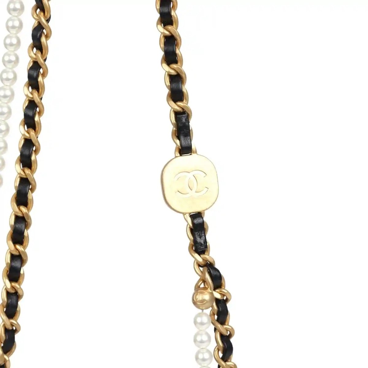 Gold and black chain strap detail with round Chanel CC medallion and pearl beads