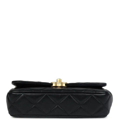 Black quilted lambskin flap bag with round gold top hardware on the back side