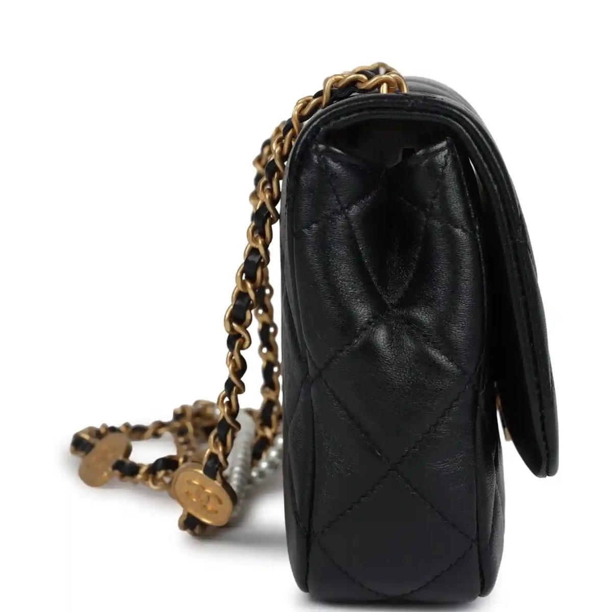 Black lambskin flap bag side view with gold chain strap and quilted stitching