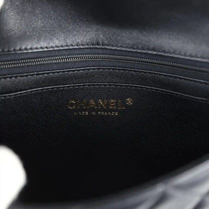 Black lambskin mini flap bag interior with Chanel logo stamp
