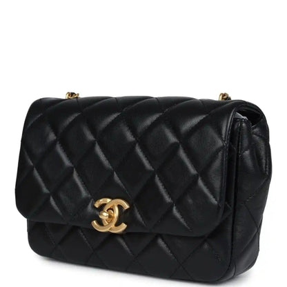 Black quilted lambskin flap bag with gold Chanel CC clasp and curved flap detail