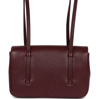 Mini tote-style clutch in dark burgundy caviar leather with top handles