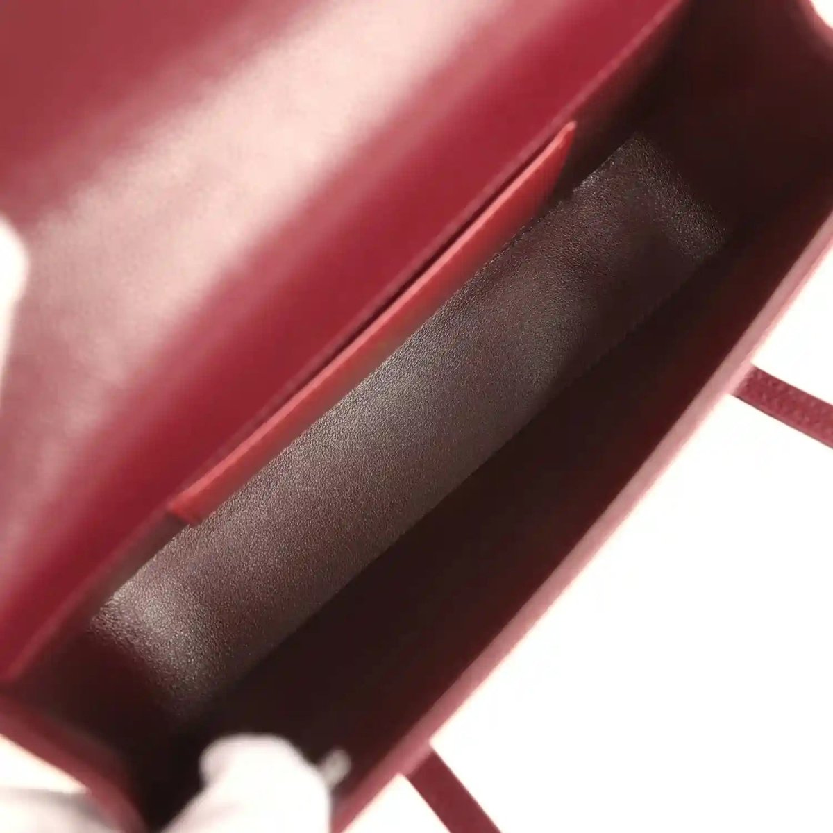 Mini clutch bag interior lining in dark burgundy with leather edge trim