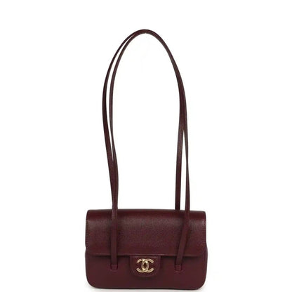 Mini clutch bag in dark burgundy caviar leather with top handles and CC emblem