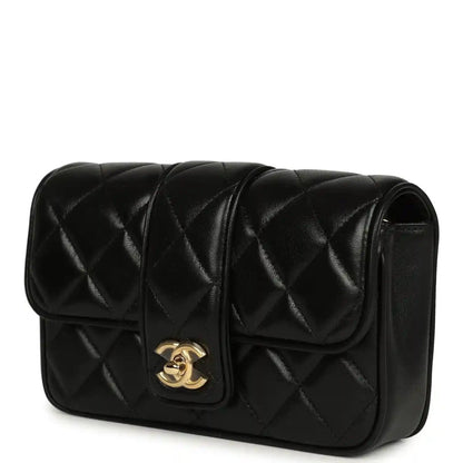 Chanel mini flap bag in black quilted lambskin with gold CC emblem on flap