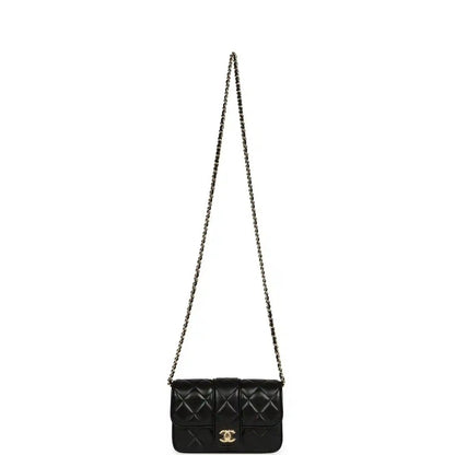 Chanel mini flap bag in black quilted lambskin with gold chain shoulder strap