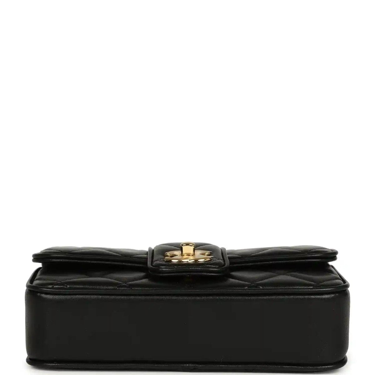 Chanel mini flap bag in black lambskin with gold clasp on top