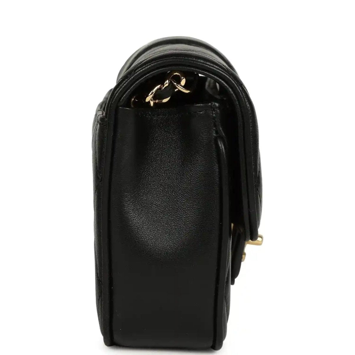 Chanel mini flap bag in black lambskin with gold chain accent and top flap