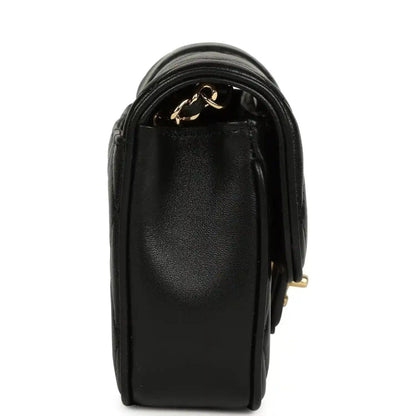 Chanel mini flap bag in black lambskin with gold chain accent and top flap