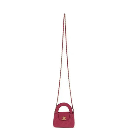 Fuchsia denim mini crossbody bag with short top handle, gold CC emblem, chain strap
