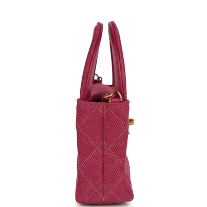 Fuchsia denim mini bag with two top handles and gold side hardware
