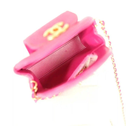 Fuchsia denim mini bag open interior with pink lining, gold hardware, and chain strap