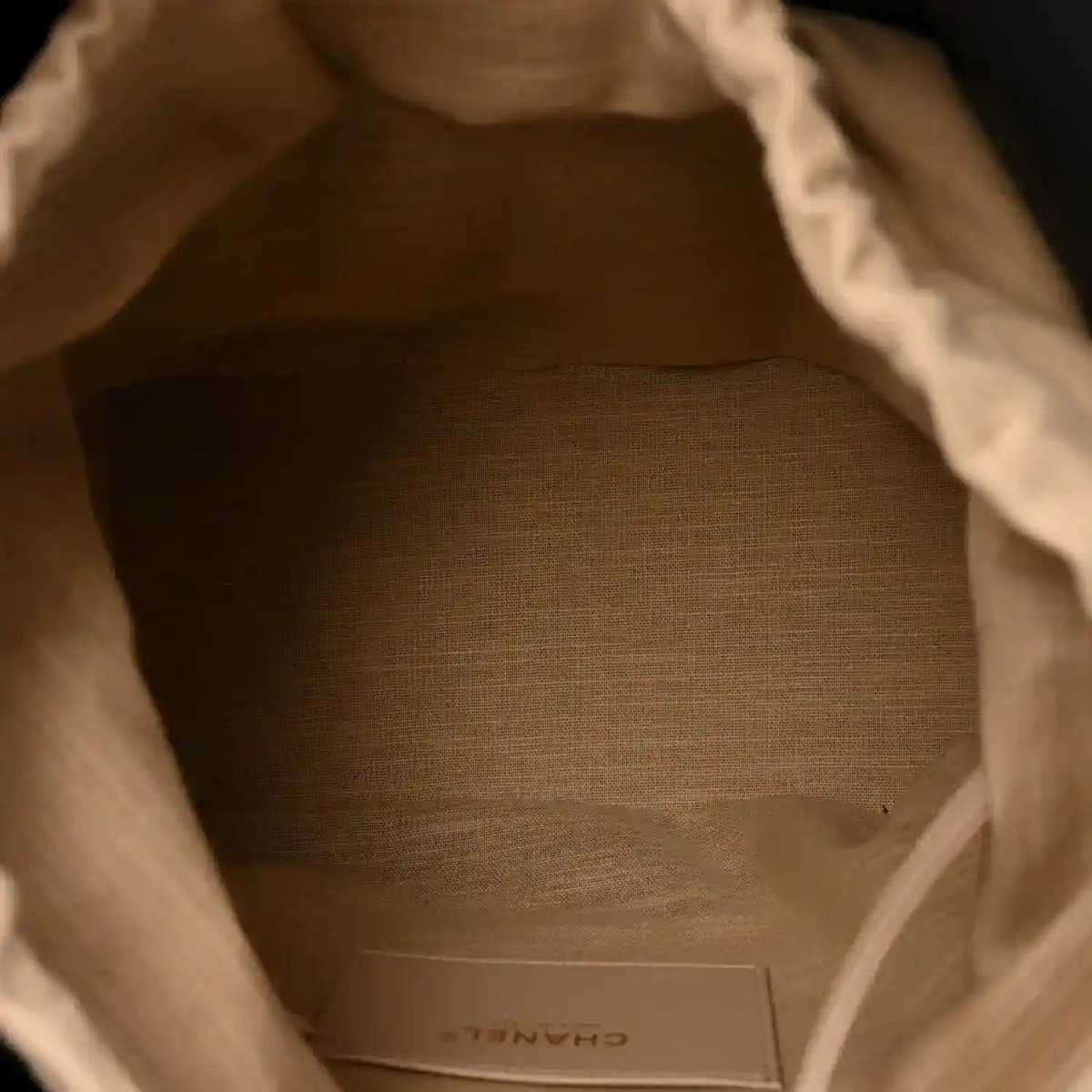 Tote bag interior lining with CHANEL label on beige fabric