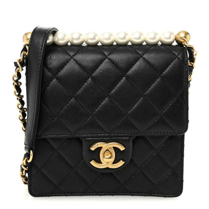 Chanel quilted black goatskin flap bag with faux pearl top detail and gold-tone CC clasp