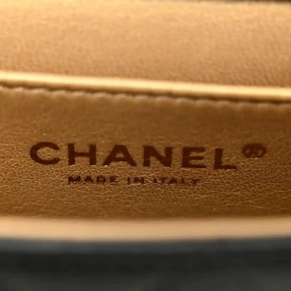 Chanel embossed leather logo patch on tan/brown interior