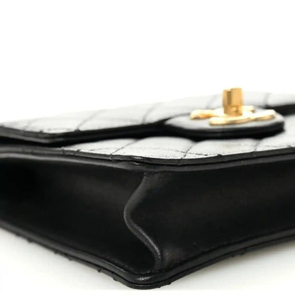 Chanel black quilted flap bag corner with gold-tone hardware and edge stitching