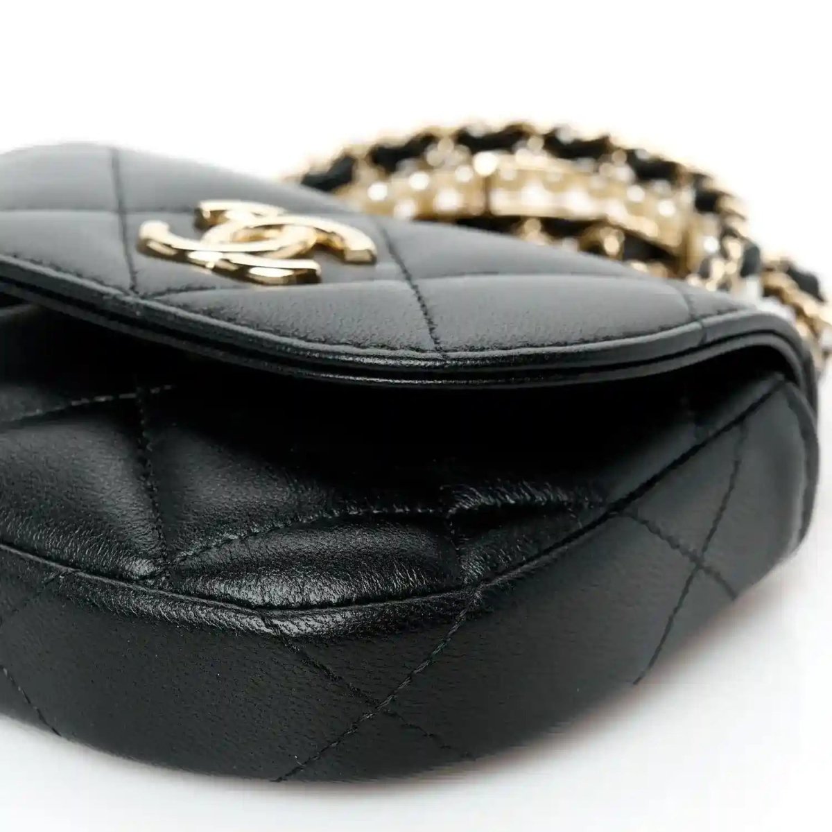 Quilted black leather clutch with gold clasp and stitched edge detail