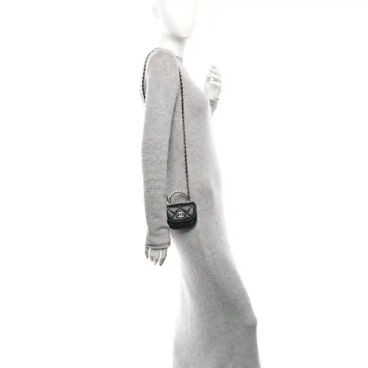 Small black quilted leather clutch with chain strap, shown worn