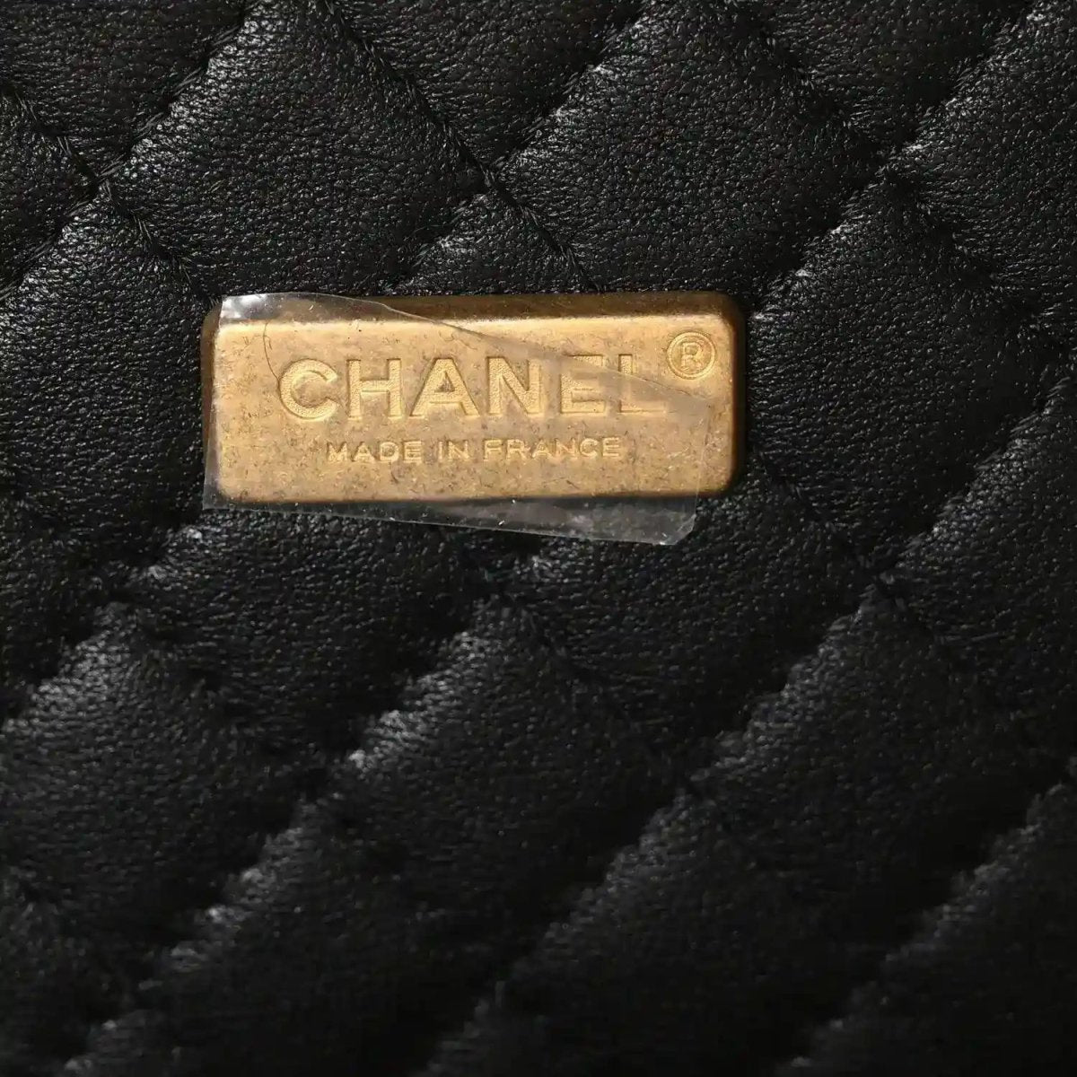 Chanel vanity case label on black quilted leather reading CHANEL MADE IN FRANCE