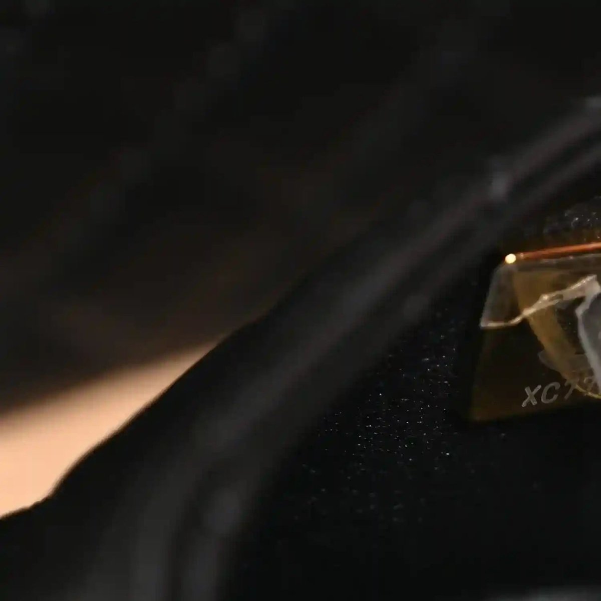Chanel vanity case close-up of black leather strap edge and gold hardware