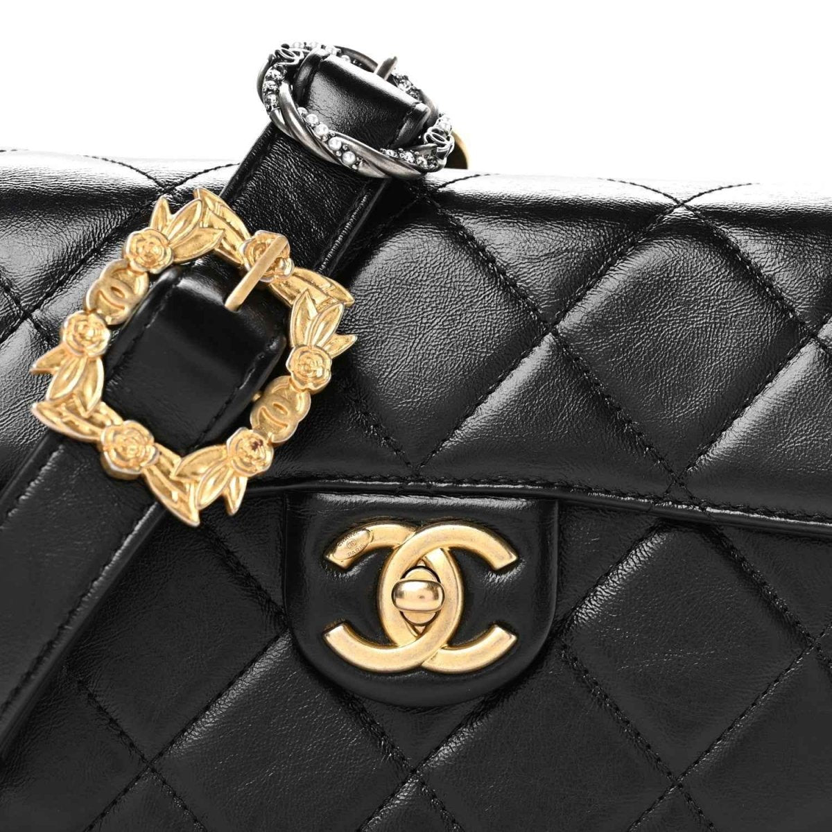 Black quilted flap messenger bag with gold-tone framed buckle and CC logo