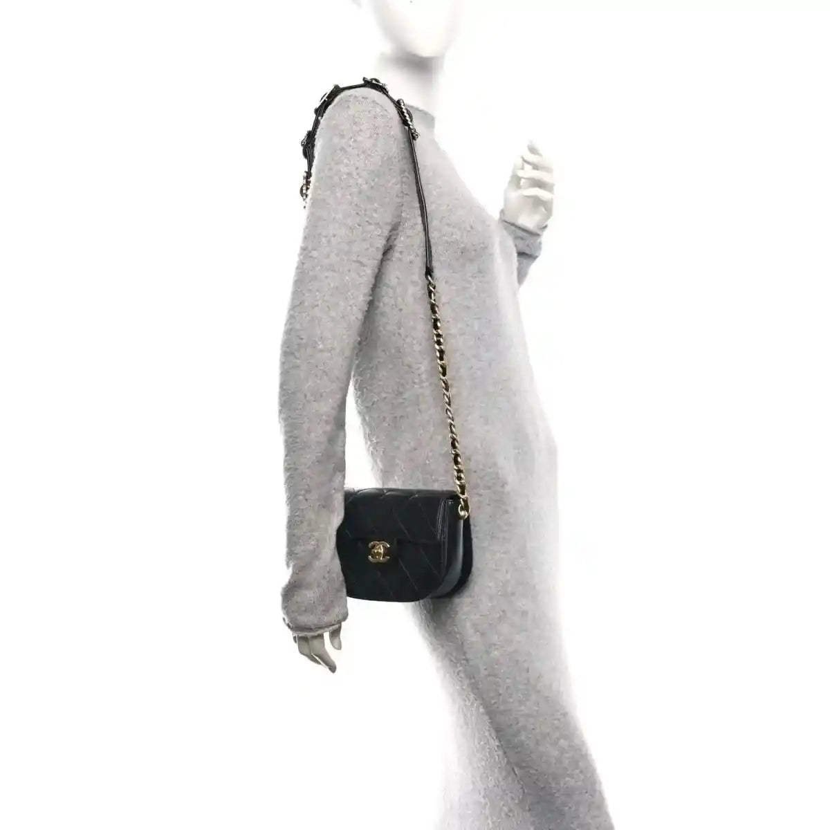 Black mini crossbody bag on chain strap with quilted design and small logo emblem