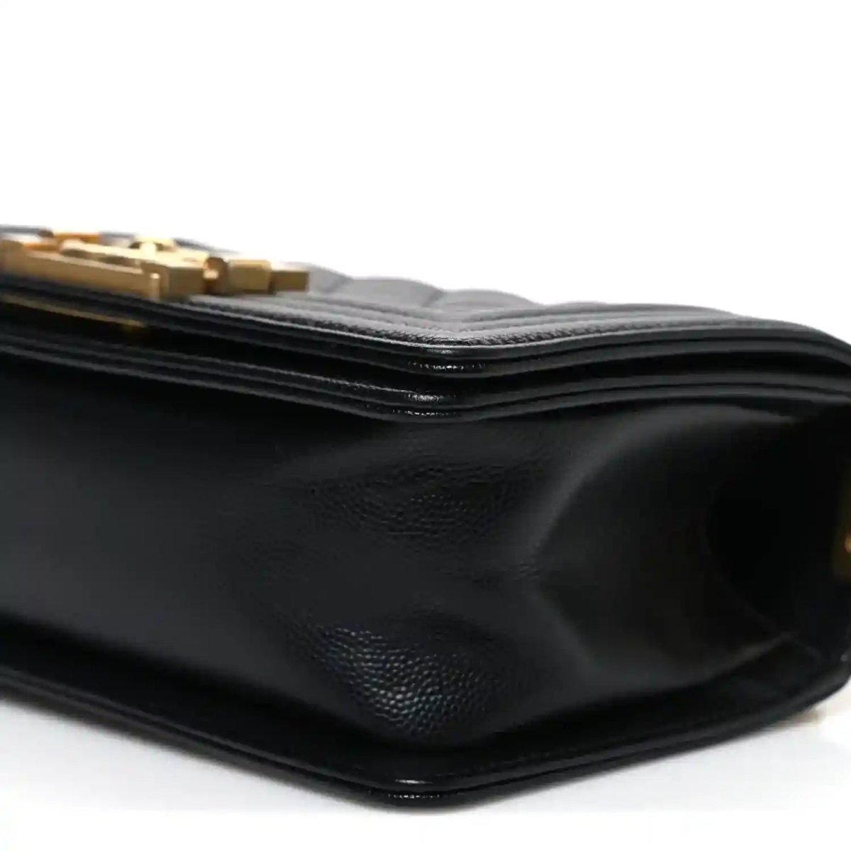 Black leather flap bag side with textured grain and stacked edge stitching