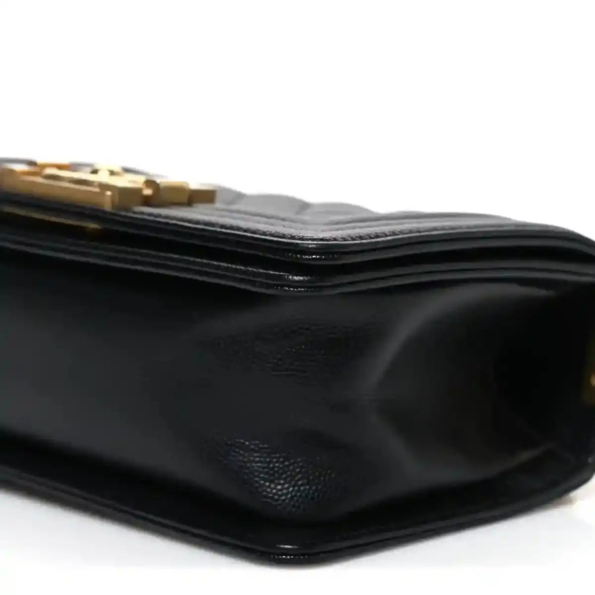 Black leather flap bag side with textured grain and stacked edge stitching