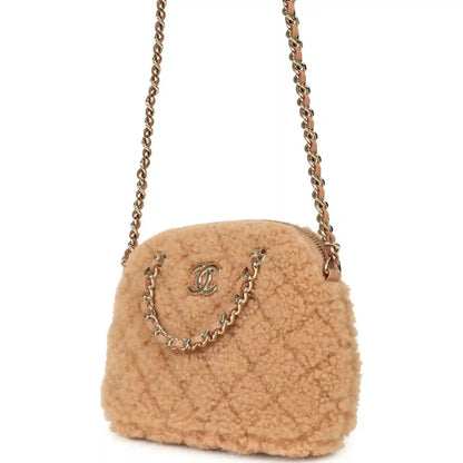 Beige shearling crossbody bag with gold chain strap and front CC logo on flap