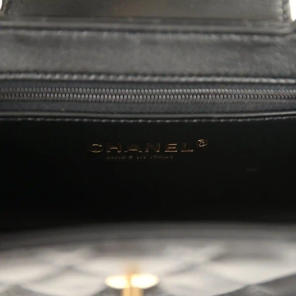 Chanel Kelly shopper bag close-up of black interior lining with Chanel text logo