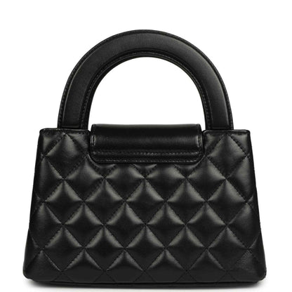 Chanel Kelly shopper bag in black quilted leather with structured top handles and front flap