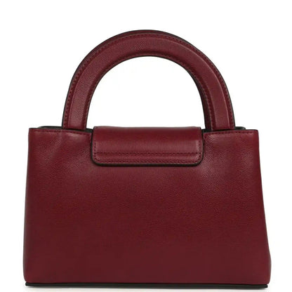 Dark burgundy caviar leather mini shopper bag with gold CC turn-lock and short top handle