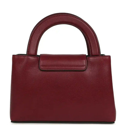 Dark burgundy caviar leather mini shopper bag with gold CC turn-lock and short top handle