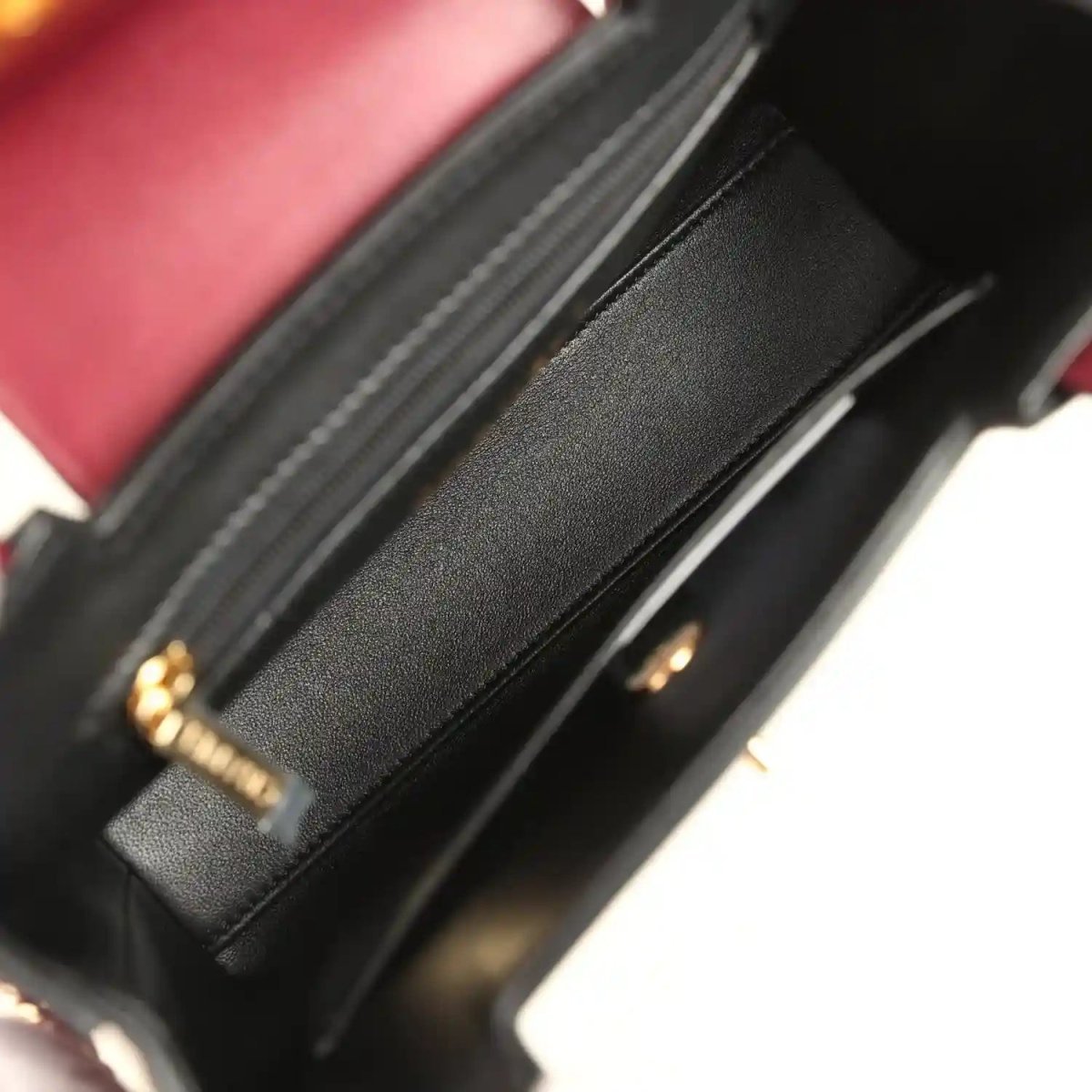 Dark interior of caviar leather mini bag with stitched seams and inner card holder