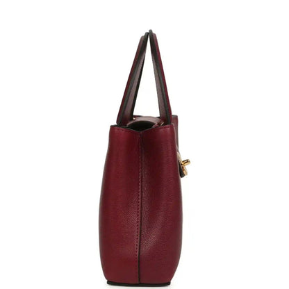 Dark burgundy caviar leather mini shopper bag side view with gold hardware accent