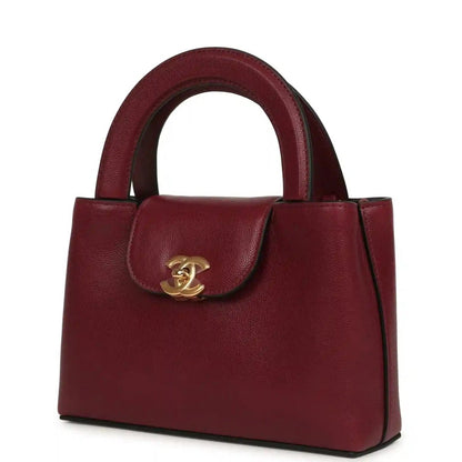 Dark burgundy caviar leather mini shopper bag front view with gold CC clasp