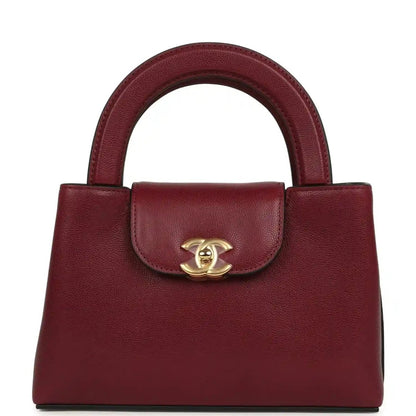 Dark burgundy caviar leather mini shopper bag with gold CC turn-lock and top handles