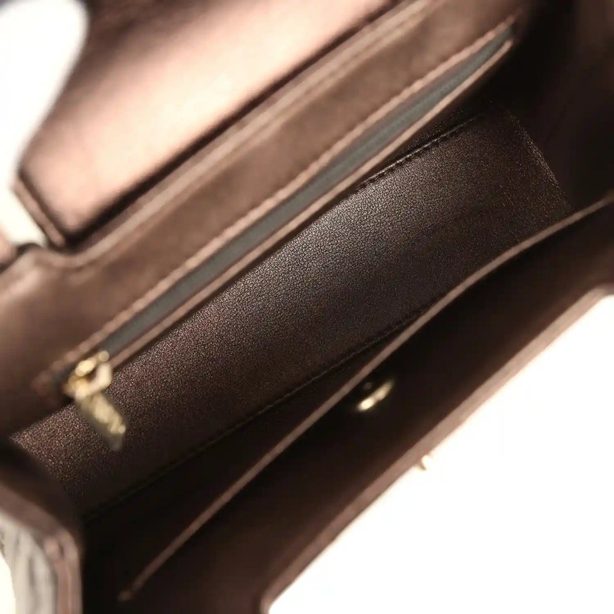 Small bag interior with dark lining, zipper track, and leather edge trim
