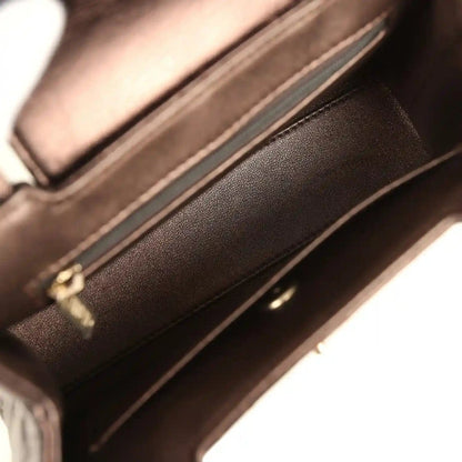 Small bag interior with dark lining, zipper track, and leather edge trim