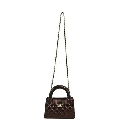 Small shopper bag in dark bronze with quilted front, CC clasp, and long chain strap