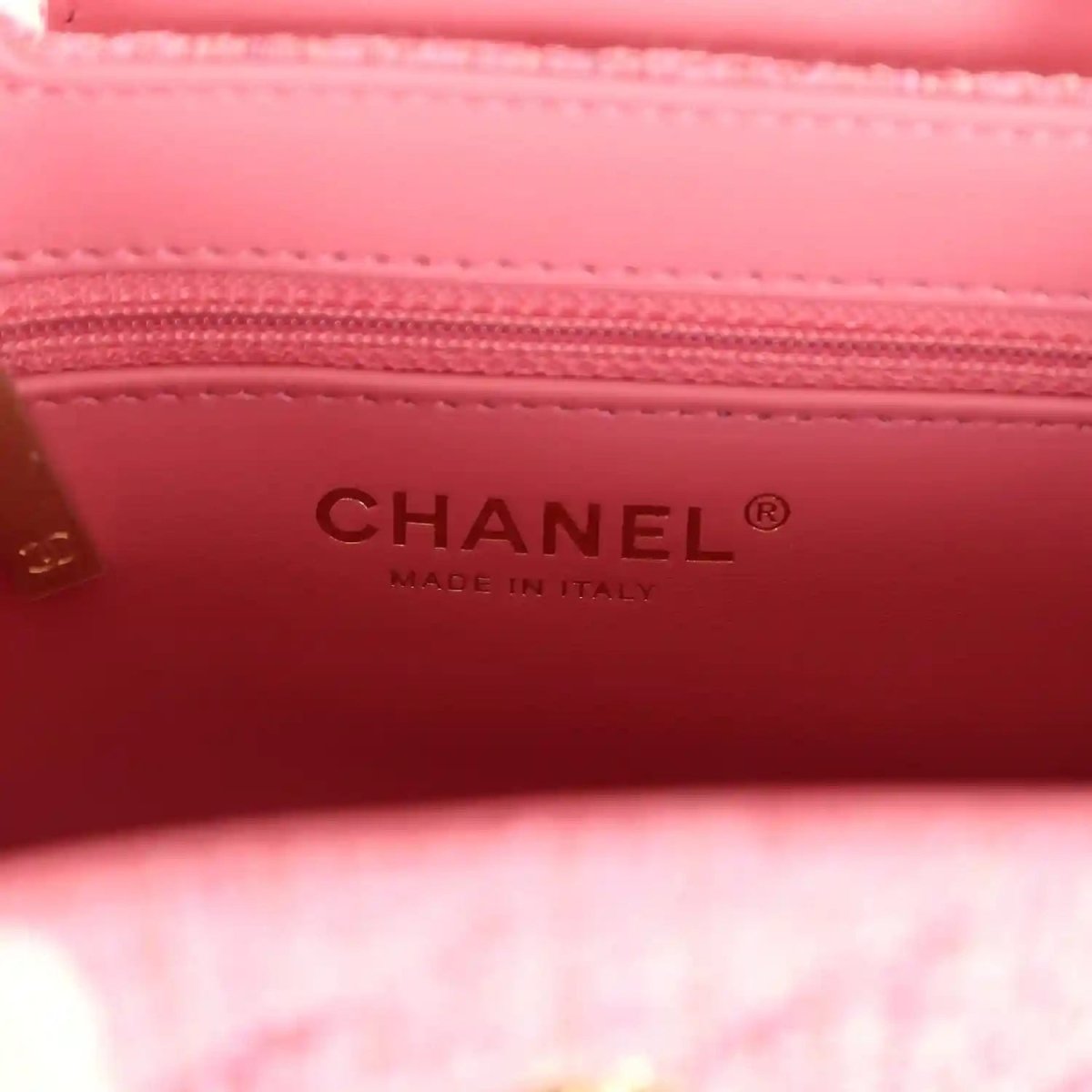 Pink leather bag interior with CHANEL text and stitched trim